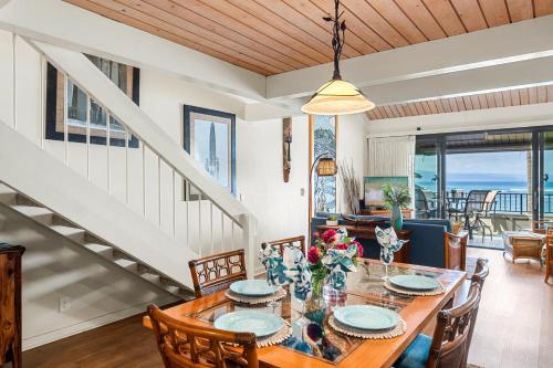 a dining room with a table and chairs at Kahana Village 3 · KHV 3 Remodeled 2BD Condo with Oceanfront Lan in Kahana