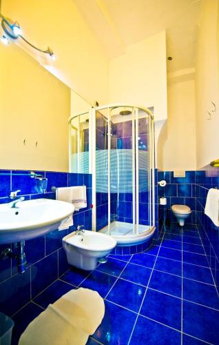 a blue bathroom with two sinks and a shower at Residenza Sole Amalfi in Amalfi
