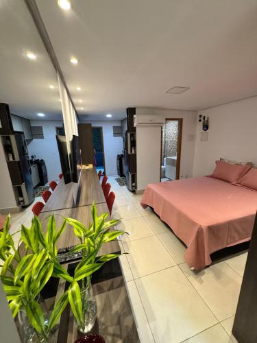 a bedroom with a bed and a couch and a table at Apartamento de um quarto com varanda externa in Bananeiras