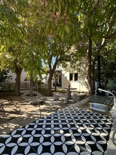 a park with a black and white floor and trees at Casa Las Victorias in Loreto