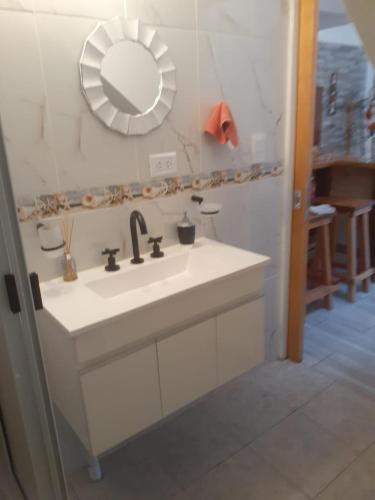 a bathroom with a white sink and a mirror at Lo de Pere in San Carlos de Bariloche