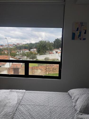 a bedroom with a large window with a view at Apartamento Entero 203 NUEVO in Guatavita