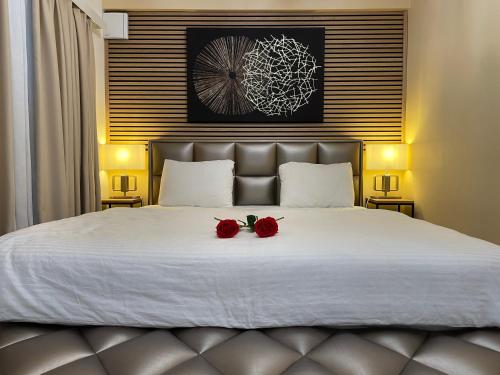 two roses sitting on top of a bed at Apartman Jacuzzi Be Happy in Zagreb