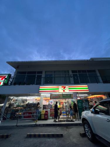 a gas station with people standing in front of it at Pure Bliss Getaway Condo Near Mactan Airport Lapu-Lapu in Lapu Lapu City