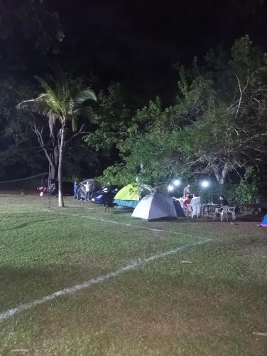 a group of tents in a park at night at hosteria y camping piedras verdes in Sopetran