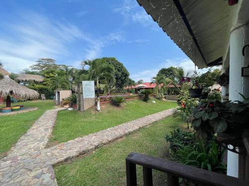 a view of a yard with a park with a bench at El Rincón de Carmentea, Casa de Campo para familias y amigos in Restrepo