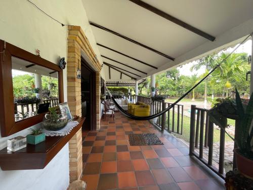 a porch with a hammock in a house at El Rincón de Carmentea, Casa de Campo para familias y amigos in Restrepo