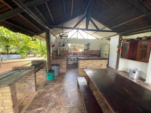 a large kitchen with wooden benches in a pavilion at El Rincón de Carmentea, Casa de Campo para familias y amigos in Restrepo