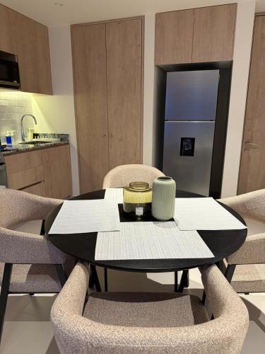 a dining room table and chairs in a kitchen at Stylish New Loft in Financial Zone and Downtown in Guadalajara