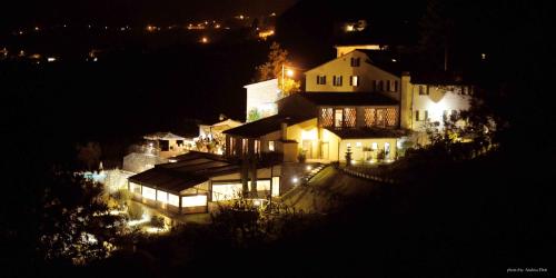 a large white house at night with lights at Tenuta San Pietro Luxury Hotel in Lucca