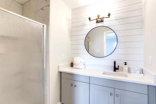 a white bathroom with a sink and a mirror at Walk 2 Beach, Boardwalk & All Broadway Attractions in Myrtle Beach