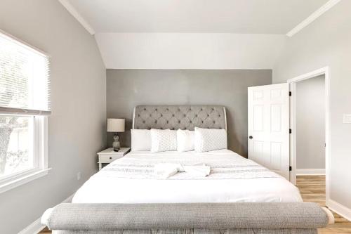 a white bedroom with a large bed with white sheets at Walk 2 Beach, Boardwalk & All Broadway Attractions in Myrtle Beach