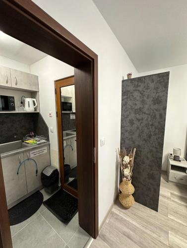 a kitchen with a door open to a kitchen with a counter at Star in Varna City