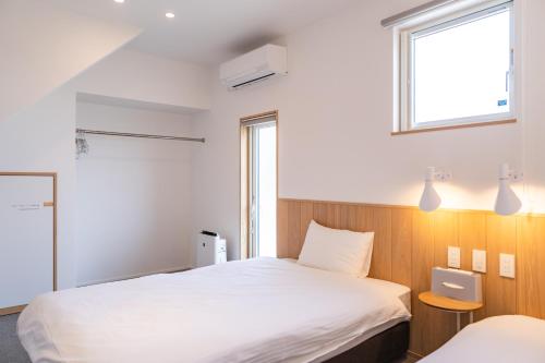 Postel nebo postele na pokoji v ubytování Beach SPA TSUDA 0 Cero棟