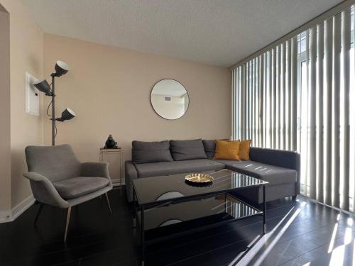a living room with a couch and a chair at The Signature at CityPlace in Toronto