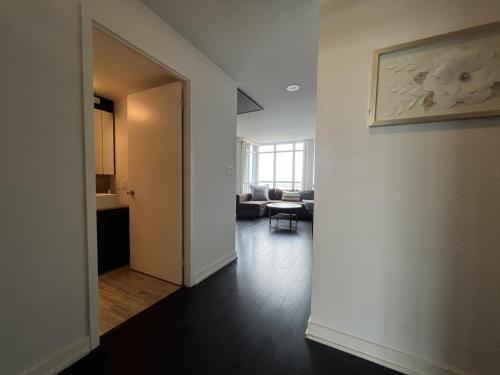 an open hallway with a room with a living room at The Signature at CityPlace in Toronto