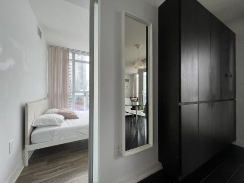 a bedroom with a bed and a large mirror at The Signature at CityPlace in Toronto