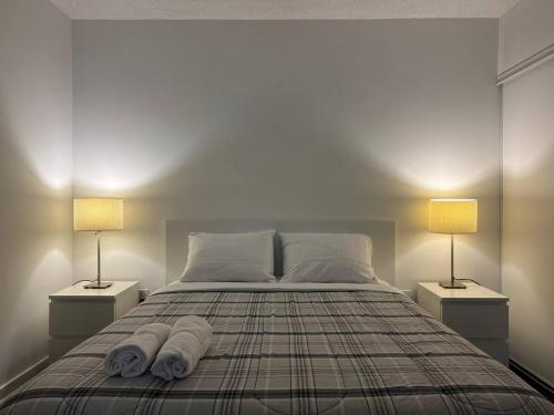 a bedroom with a bed with two lamps on it at The Signature at CityPlace in Toronto