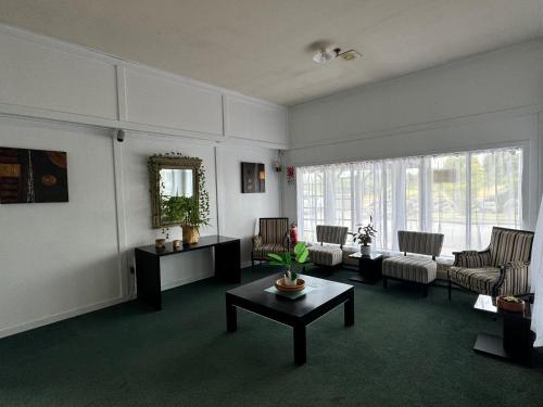 a living room with a couch and a table at Tokaanu Hotel in Tokaanu