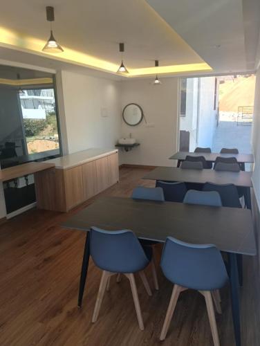 a conference room with a table and blue chairs at Spring Valley Enclave in Kodaikānāl