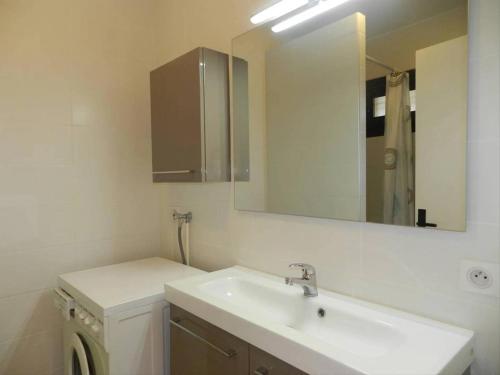 une salle de bain avec un lavabo et un miroir dans l'établissement Appartement T2 avec piscine et parking pour 4 personnes - FR-1-610-103, au Lavandou