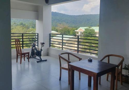 a room with a table and chairs and a large window at Lotus Phú Quốc Hotel in Phu Quoc