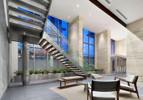 a staircase in a building with a table and chairs at The Signature at CityPlace in Toronto