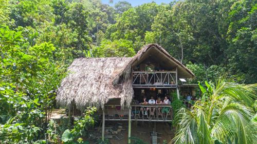 a group of people in a hut in the jungle at Finca La Selvita Chocolate experience in Buritaca