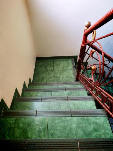 a set of stairs in a room with green floors at GREEN Homestay in Bandung