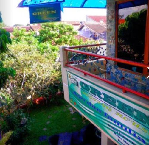 a balcony of a building with bushes and trees at GREEN Homestay in Bandung