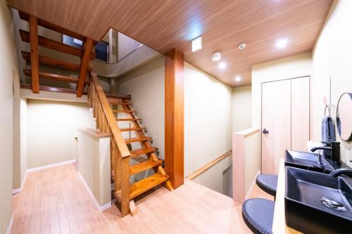 a room with a staircase in a tiny house at 安 Ann サウナで整う貸切の宿 USJ 万博会場近く 無料駐車場 寝室6 バスルーム4点 in Osaka