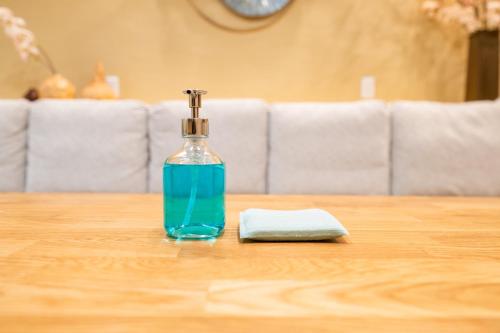 a bottle of soap sitting on top of a table at 安 Ann サウナで整う貸切の宿 USJ 万博会場近く 無料駐車場 寝室6 バスルーム4点 in Osaka