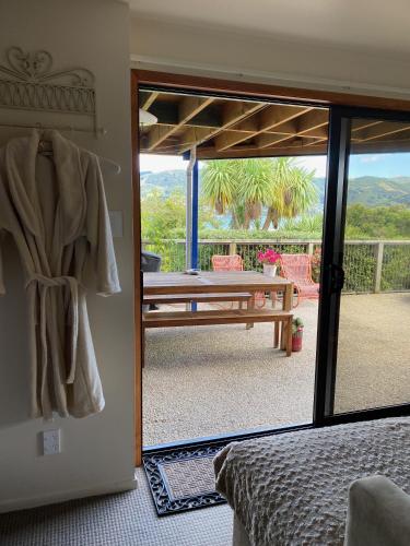 a bedroom with a door open to a patio with a pool table at Otago Peninsula Paradise in Dunedin