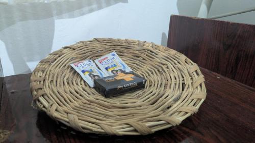 a basket with a book and books on top of it at Aalmaram By Kizhakeyil Private Pool Heritage Villa in Trivandrum