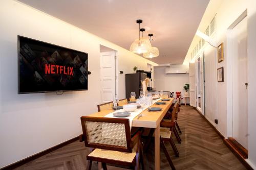 a long dining room with a long table and chairs at Designer house Chao Phraya River - OH Homes 12 in Bangkok