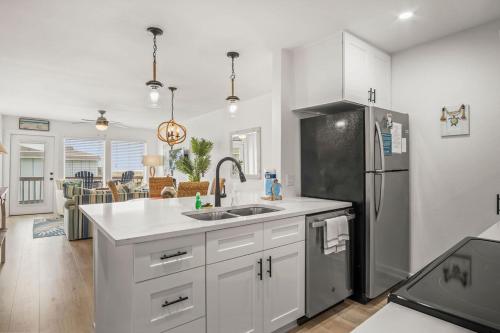 a kitchen with a sink and a refrigerator at Casa Sea-Esta - OCEAN VIEWS in Port Aransas