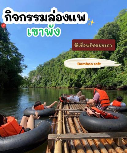 a group of people laying on rafts on a river at Khao Phang Camping in Ban Pha Saeng Lang