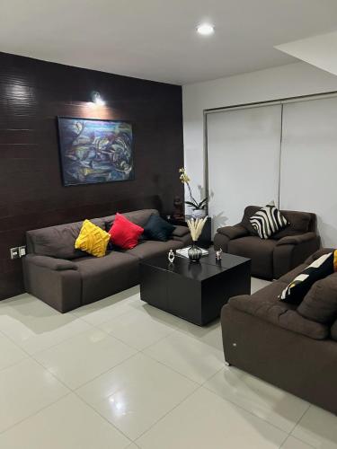 a living room with two couches and a coffee table at Hermoso Penthouse in Tuxtla Gutiérrez
