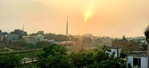 a view of a city with a rainbow in the sky at Varanasi River View Holiday Homestay Dormitory and Hostel in Varanasi