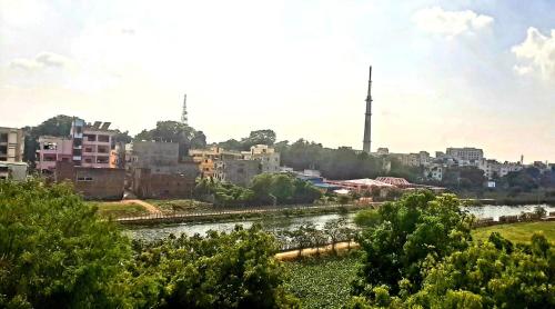 a view of a city with a river and buildings at Varanasi River View Holiday Homestay Dormitory and Hostel in Varanasi