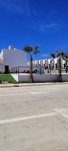 an empty street with palm trees in front of a building at Condo located 8 min from DT & 15 min from Airport in San José del Cabo