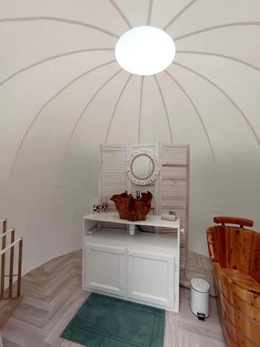 a room with a vanity with a mirror and a ceiling at Entre 2 bulles in Entre-Deux