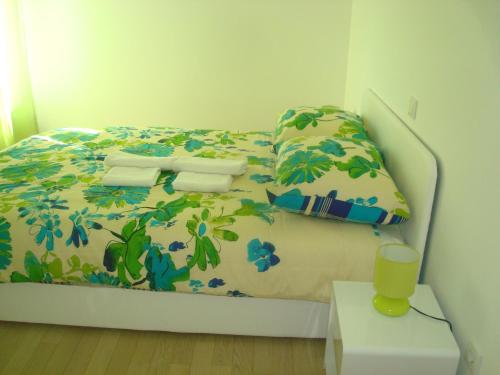 a bedroom with a bed with a floral bedspread at Apartment Nena in Krk