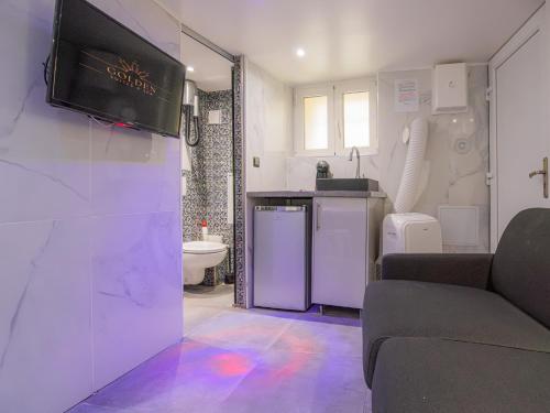 Il comprend un salon avec une télévision murale et une salle de bains. dans l'établissement Le Ronali - Jacuzzi, à Manosque