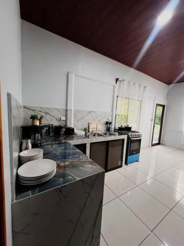 a kitchen with a counter with plates on it at Teyú Green Cottage in Cuatro Esquinas