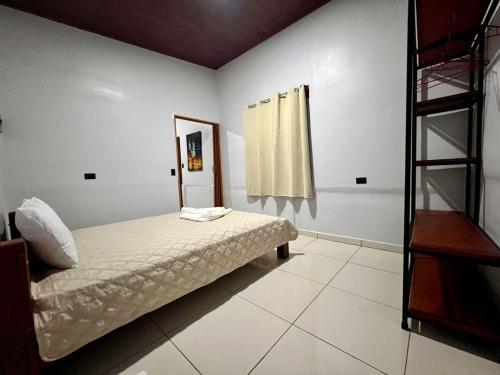 a bedroom with a bed and a mirror at Teyú Green Cottage in Cuatro Esquinas