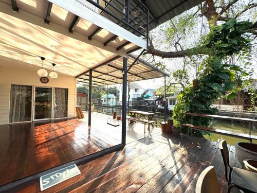 an open patio with a table and a tree at DD Canel in Bangkok