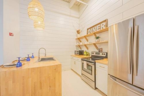 a kitchen with a sink and a refrigerator at Darlin' Downtown Dawghouse in Athens