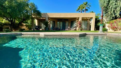 a large swimming pool in front of a house at Double Eagle in Rancho Mirage