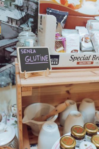 a store shelf with a sign that says scrana glutine at Le Calvie, country house in Camerino